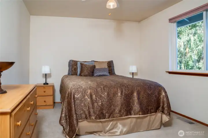 Classic, well-sized bedroom with a window view and closet, providing simple comfort and functionality.