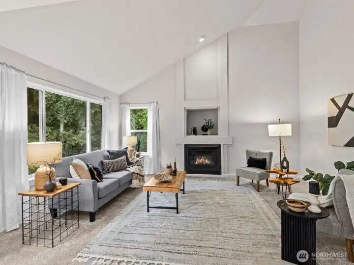 Vaulted ceilings and another gas fireplace elevate this space and make it a perfect spot to watch tv.