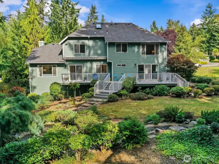 Meticulously landscaped on the front half and left more natural on the back half into the greenbelt.
