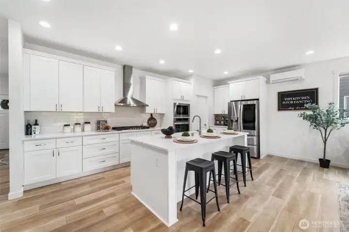 Gourmet kitchen with quartz countertops, designer backsplash, stainless steel appliances