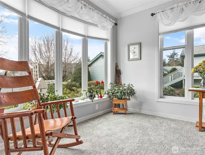 Lots of natural light from these large picture windows make this a great space for plants or soaking in the sun!