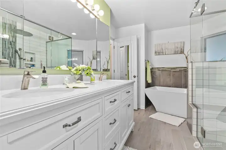 Primary Bathroom - fully remodeled - new soaker tub, glass wall shower that is wheelchair accessible, heated tile floors and a double vanity