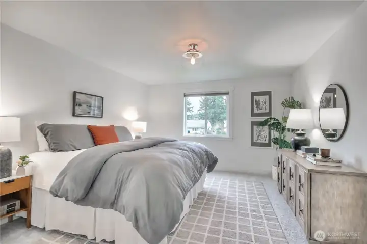 The primary bedroom easily fits a king-size bed, two nightstands and dresser with room to move around.