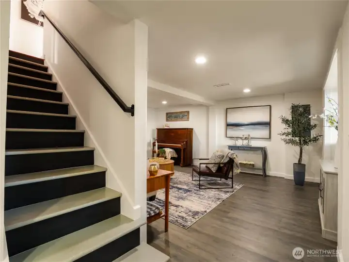 The lower floor has many versatile spaces including a workout/office space, family room and desk area.