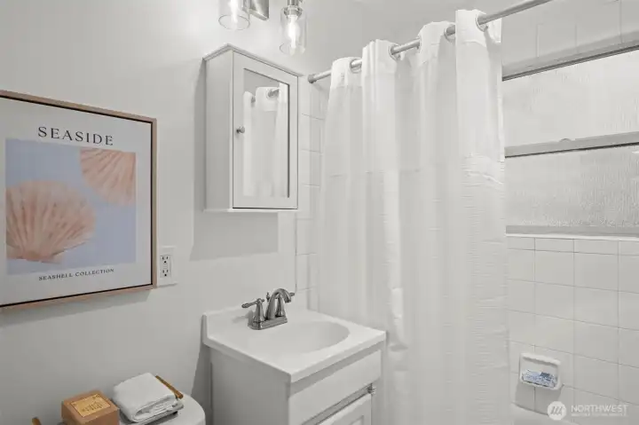 Charming tile bathroom with new vanity & light