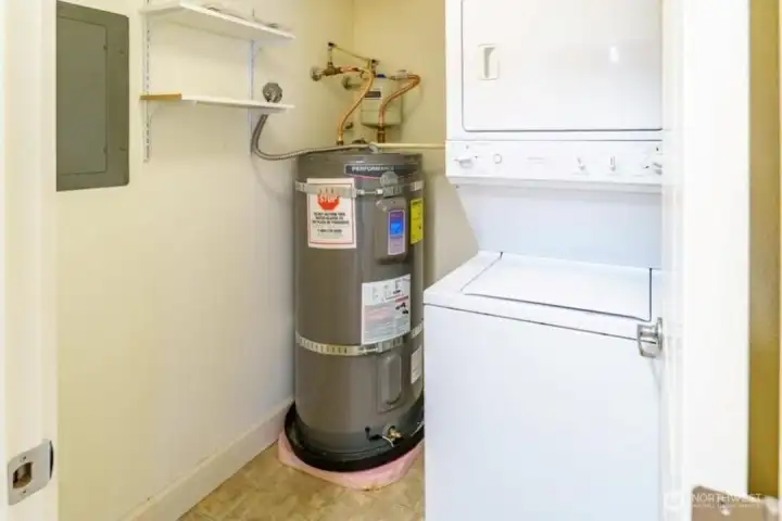 Utility room with in unit washer / dryer and new hot water heater.