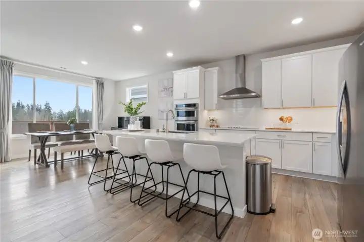 Chef's kitchen featuring a large eat-in island and quartz countertops.