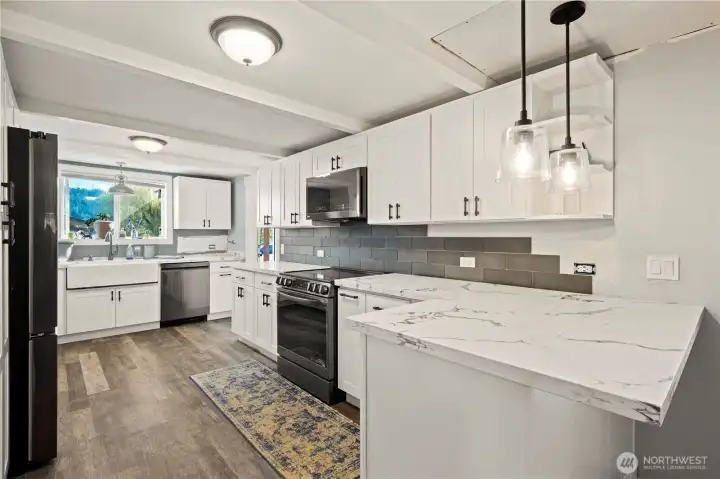Renovated Kitchen with Quartz Counter tops and Pendant Lighting