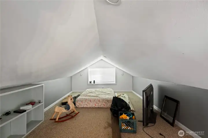 Loft with Vaulted Ceilings and Windows