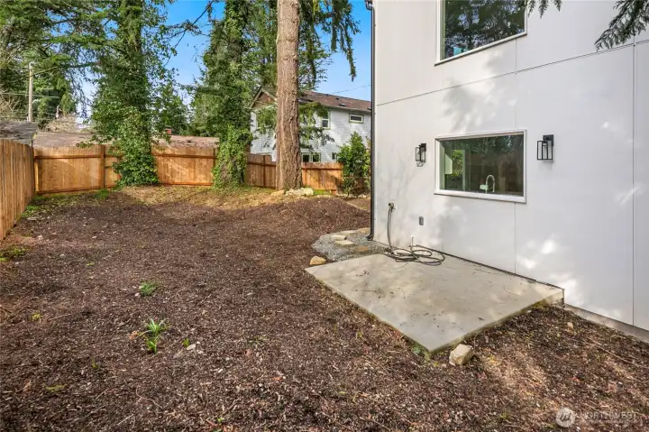 Private secluded fenced yard with expansive patio perfect for entertaining.
