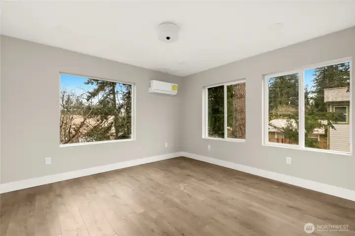 Upper level primary suite with mini-split heating/cooling, expansive windows and LED lighting.