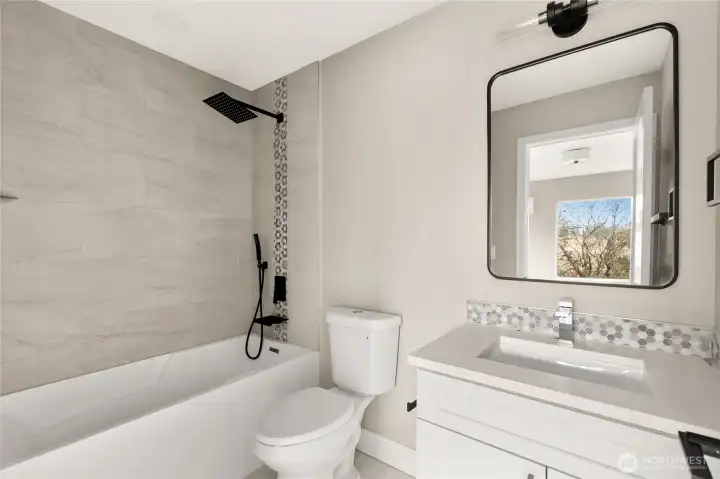 Luxury en-suite bathroom with custom vanity, Quartz counters with Italian tile floors, shower walls and backsplash.