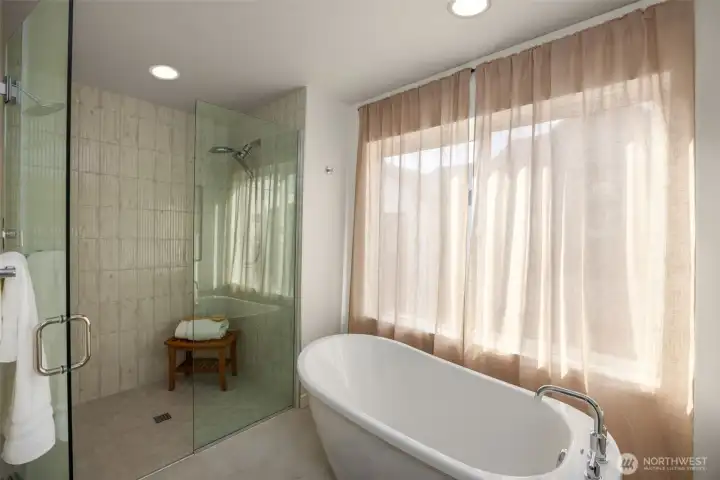 Indulge in a spa-inspired primary bath, complete with a contemporary soaking tub and high-end designer fixtures