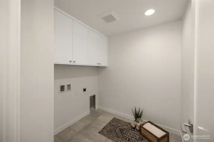 Thoughtfully placed laundry and utility zones provide convenience without sacrificing the home’s sleek design