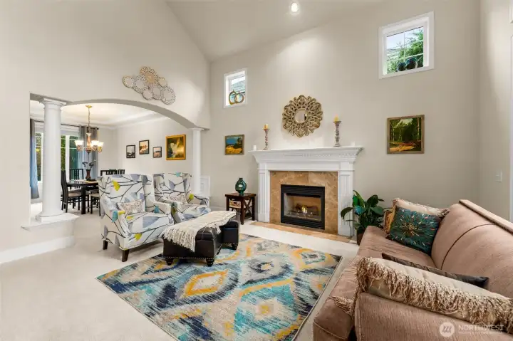 Formal living room with a gas burning fireplace connects to the well-appointed dining room.