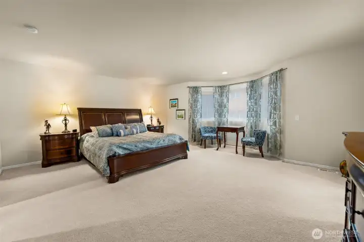 A sumptuous primary bedroom with a spa-style 5-piece primary bathroom and a huge walk-in closet