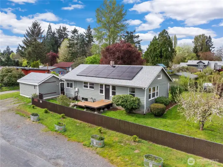Front of house and gorgeous yard