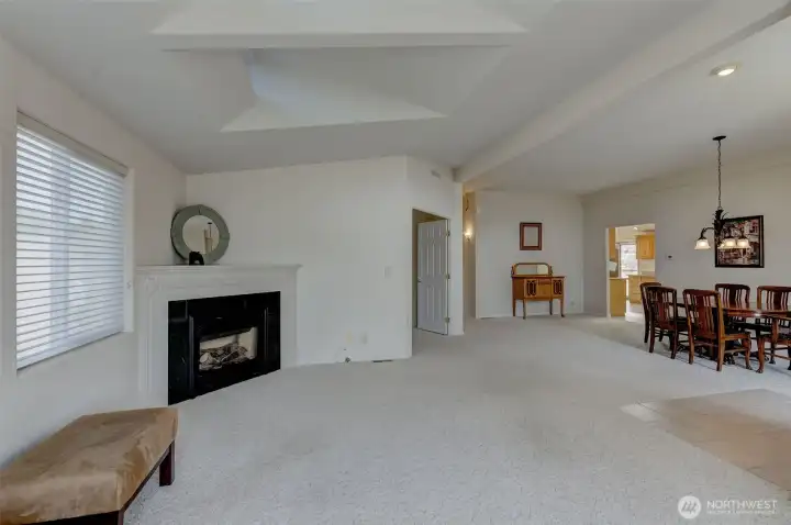 The living area flows easily into the formal dining area, kitchen, and den/office.