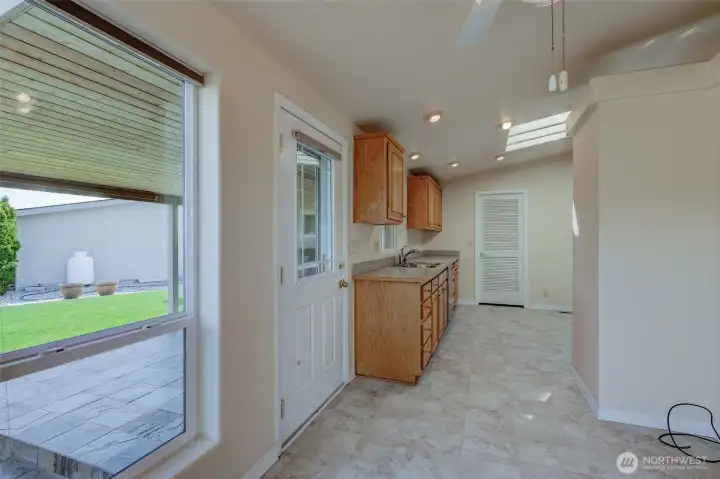 The door at left leads out to a wonderful patio covered boasting a gorgeous wood ceiling & stone tile floor!