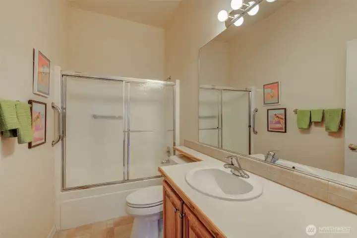 Main bathroom has a full size tub/shower and plenty of counter space.