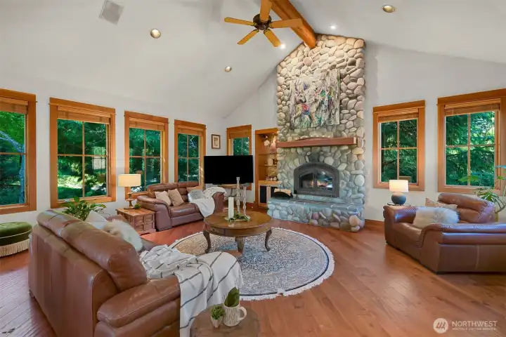 Large wood-framed windows capture panoramic views of the fairways.
