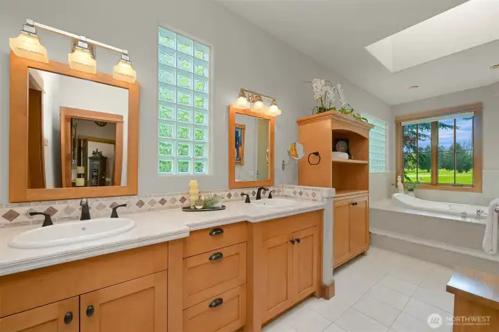 Spa-inspired primary bathroom with a soaking tub, walk-in shower, and generous closet.