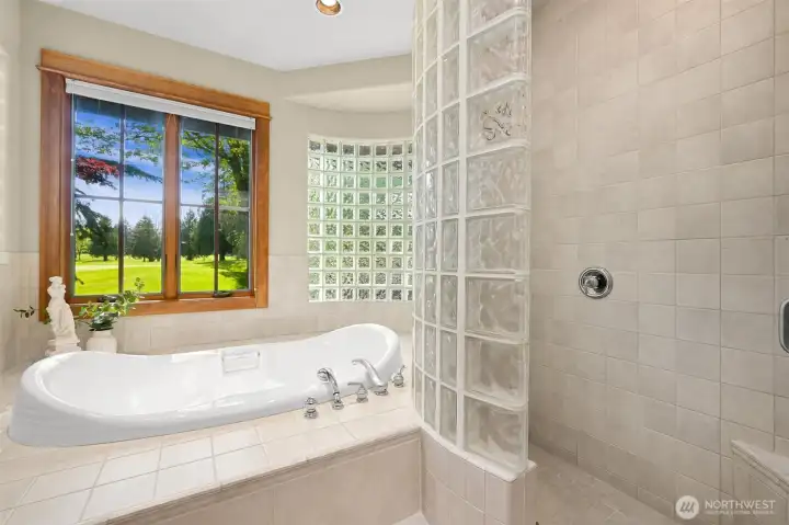 Gorgeous setting with soaking in the tub and large walk-in tiled shower.