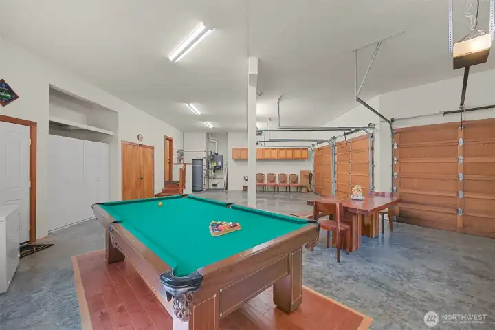 Oversized three-car garage with plenty of room for vehicles and storage.