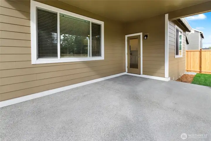 This fully landscaped and irrigated yard features a covered patio, lush greenery, and a full privacy fence—perfect for relaxing or entertaining year-round. With HOA-maintained front yard care, the outdoor space offers beauty, convenience, and low-maintenance living.