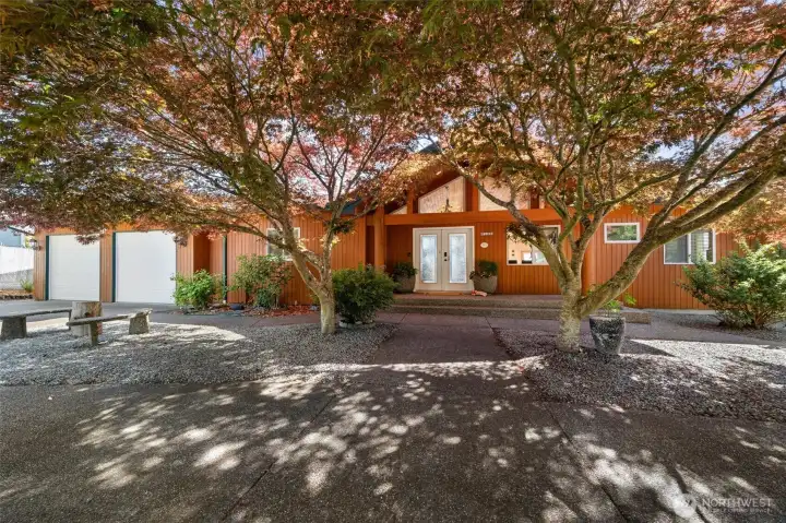 Inviting front entry framed by mature Japanese maples.