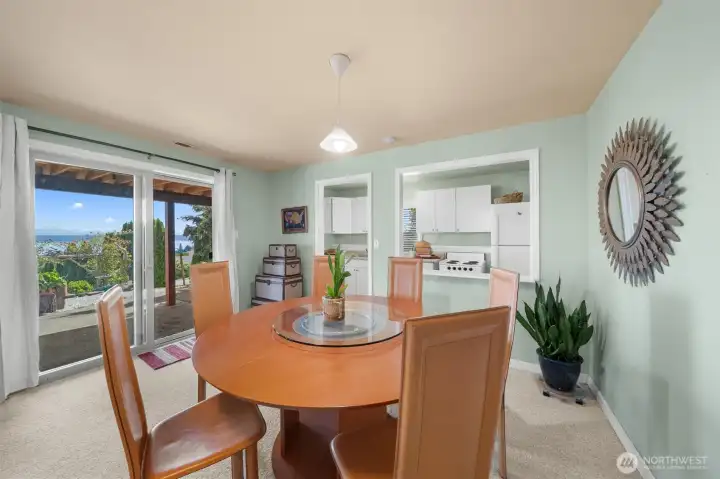 Lower-level dining area with a second kitchen, water views, direct patio access, and a separate entrance—ideal for guests or multi generational living.