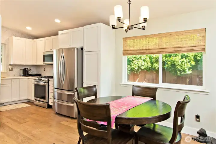 The eating space transitions off of the Kitchen. Notice the Hallmark engineered hardwood floors throughout!
