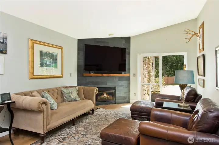 Cozy yet spacious living room with gas fireplace vaulted ceiling and Hallmark engineered hardwood floors!