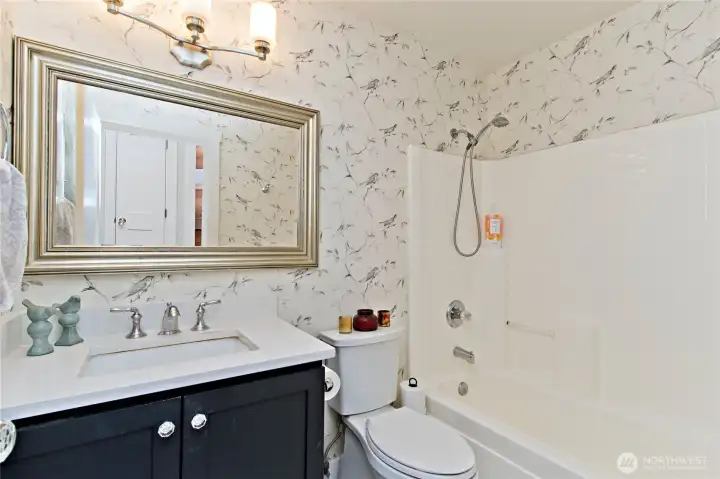 Hallway / guest bathroom is conveniently located across the hall from two of the bedrooms. Note the upgraded cabinet and Quartz countertop!