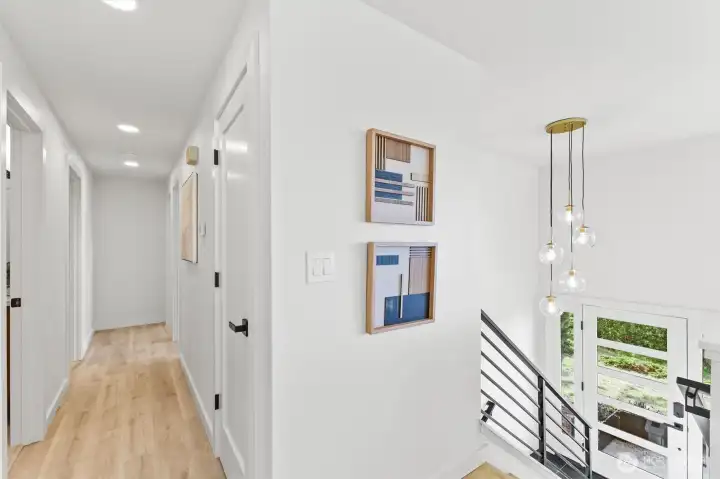 Hallway to bedrooms and stairs to lower level Hallway to bedrooms and stairs to lower level