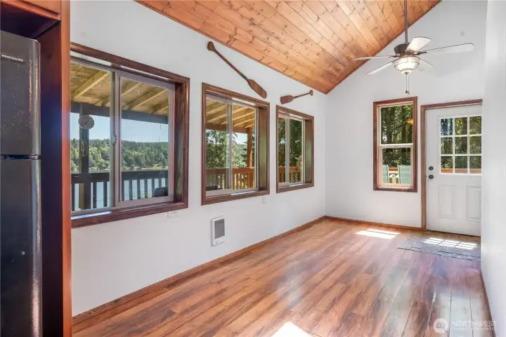 Dining area with lots of windows and vaulted ceiling. Dining area with lots of windows and vaulted ceiling.