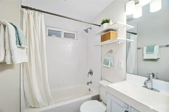 The main floor bathroom sits between the two bedrooms.  This is one of three FULL baths.