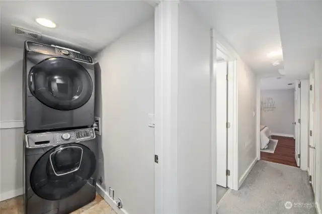 The laundry room has newer stackable washer and dryer.