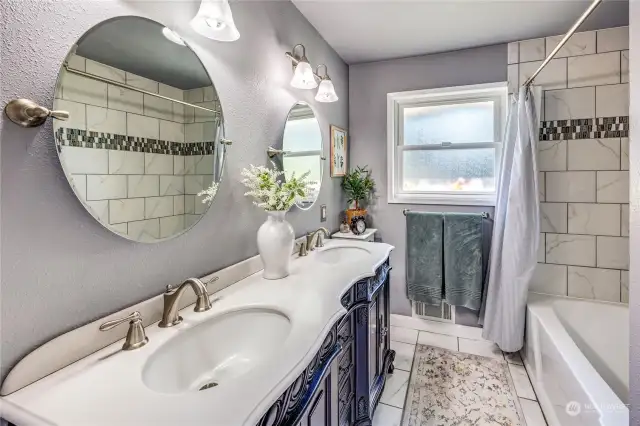 Full bathroom on the main level has been completely remodeled and features dual sinks and tile flooring.