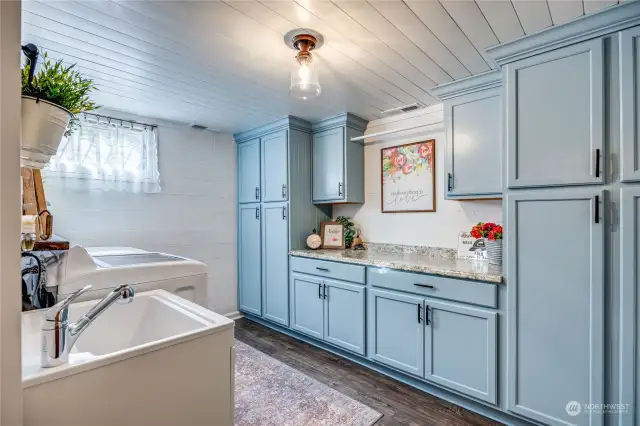 This is one of the most lovely laundry rooms I have ever seen! Tons of storage, space and both pretty & practical.