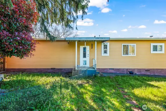 Side door for convenience to the fully fenced back yard.