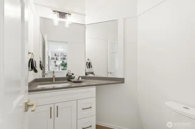 The guest ½ bath has been updated with a new vanity with quartz counter and new lighting.