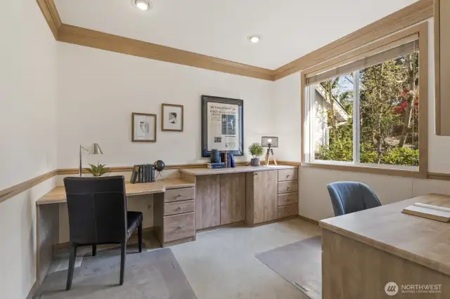 French doors off the foyer lead to the office with 2 maple built-in desks and filing cabinetry.