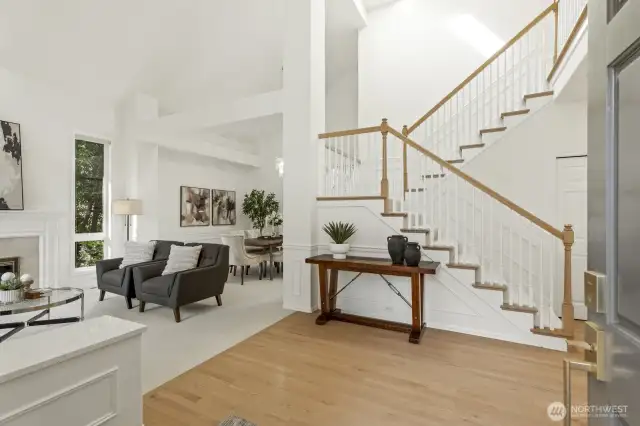 The east facing front covered entry of the main house has double doors that lead to the 2 story foyer with wainscoting, art niche shelving and open to the formal rooms.