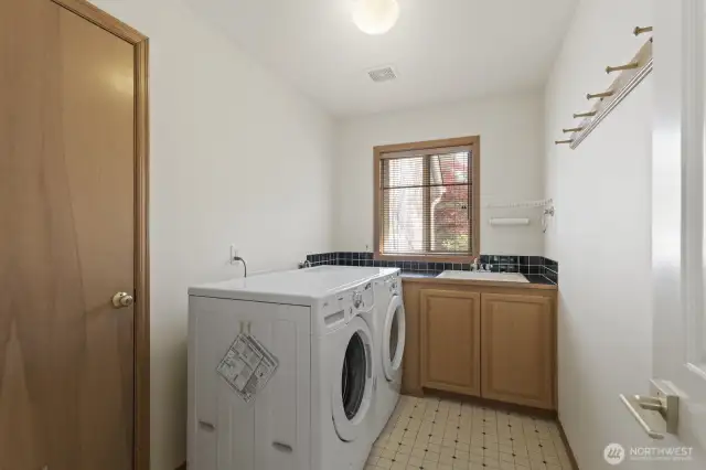 The laundry room on the main floor and 1 of 2 garage entrances are found here. Additionally, there is a mud room off the slate hallway behind the family room that leads to the garage.