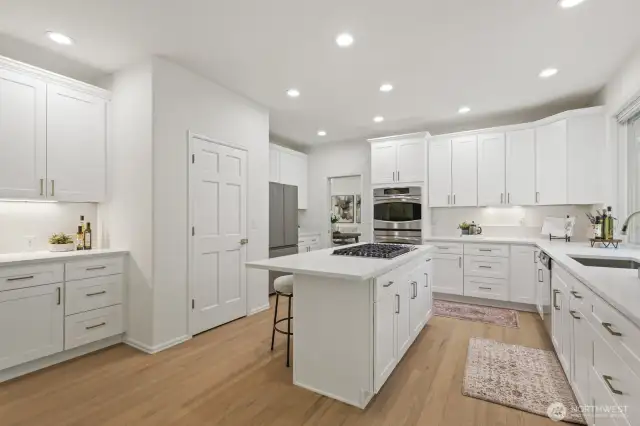 Stainless appliances including a new refrigerator, double ovens, 5-burner gas stove and coffee bar.