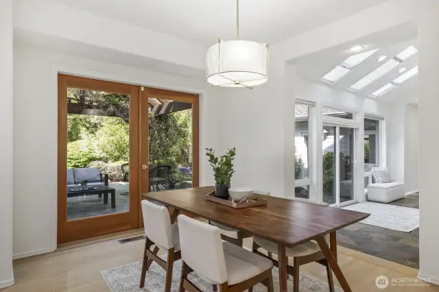 The adjacent informal dining area features French doors to the covered stone patio and the backyard.