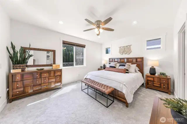 Primary bedroom with ceiling fan and plenty of space for you to bring in your own bedroom pieces