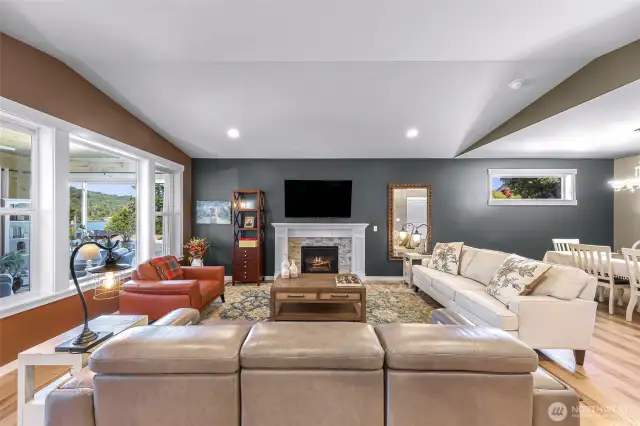 Bright natural light fills this living space while also feel cozy with propane fireplace.