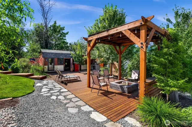 Love to entertain, or just enjoy the sunrise and/or sunsets? We have the perfect place for you. Custom built pergola with fire pit and plenty of space for friends! Off in the distance is another incredible detached space....